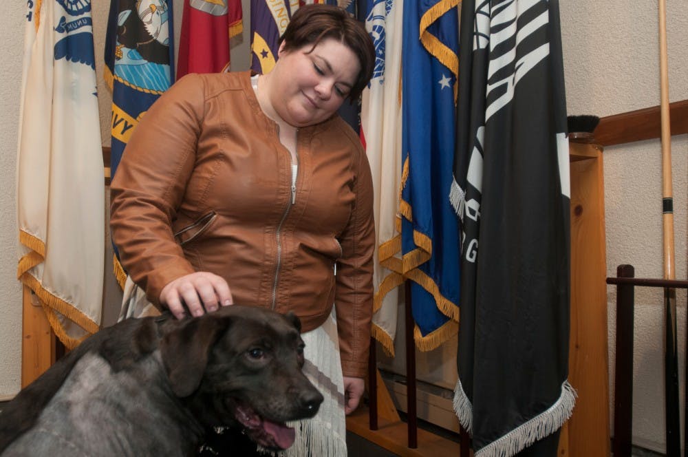 Neuroscience senior Katharine Bruce poses for a photo with her service dog, Cadence, on March 14. 2016 at the American Legion at 2949 S Waverly Hwy. in Lansing. Bruce and Cadence have been together for seven years. 