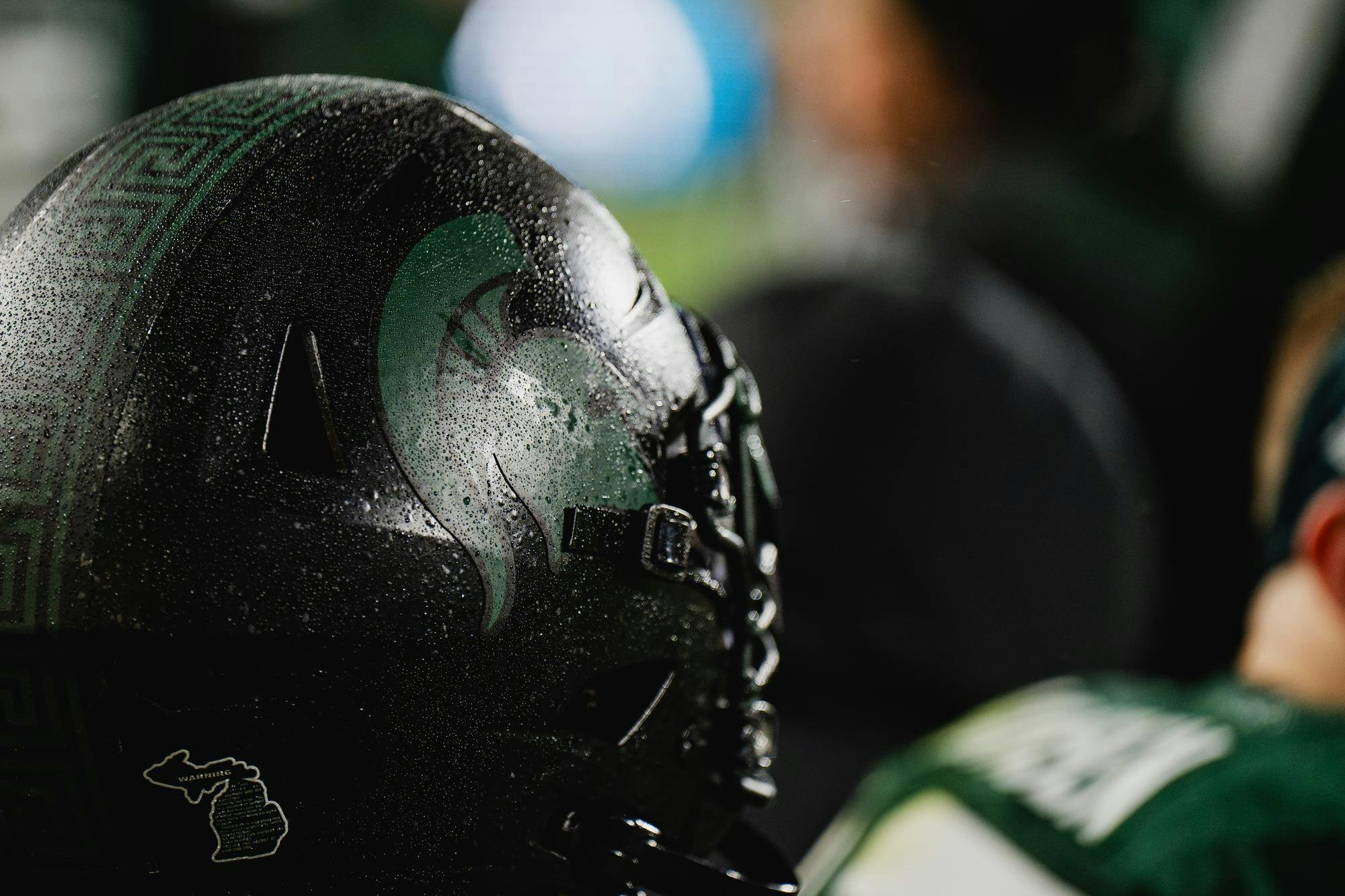 <p>MSU football helmets glisten in the rain during a game against Purdue at Spartan Stadium on Nov. 22, 2024.</p>