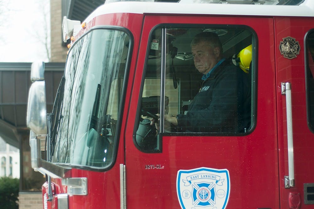 	<p>East Lansing firefighter Jim Pontack pulls the engine out of the garage to check the pump Dec. 3, 2013, at the East Lansing Fire Department, 1700 Abbot road. Pontack, in addition to working at the fire station, is a vocalist in the musical group &#8220;The Squids.&#8221; Danyelle Morrow/The State News</p>