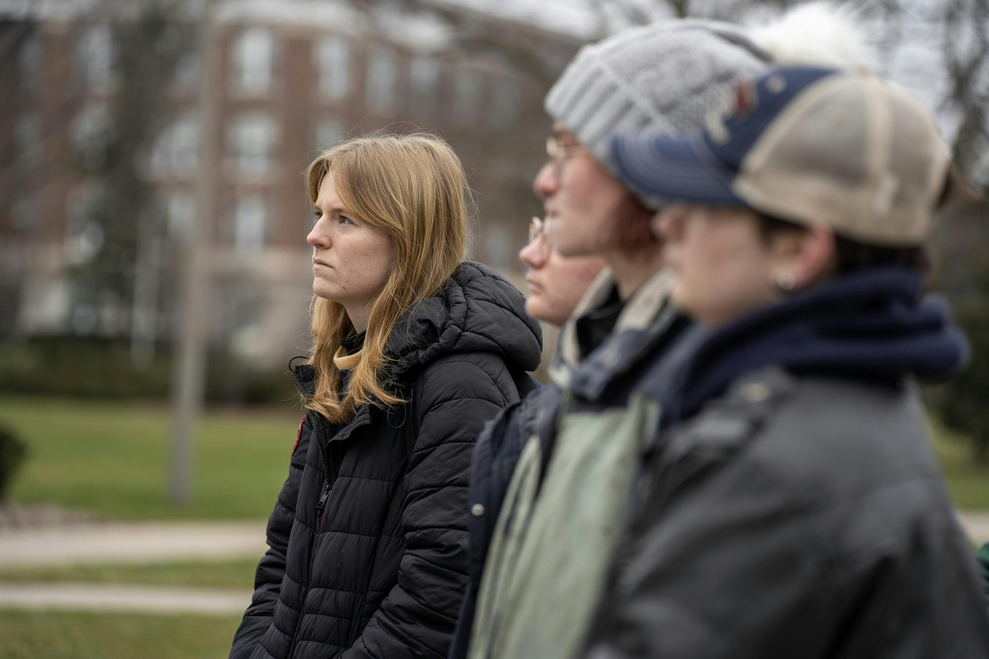 MSU Students listen to their peers speak at the protest of the opening of Berkey Hall in front of the John A. Hannah Administration building on Jan. 8, 2024.