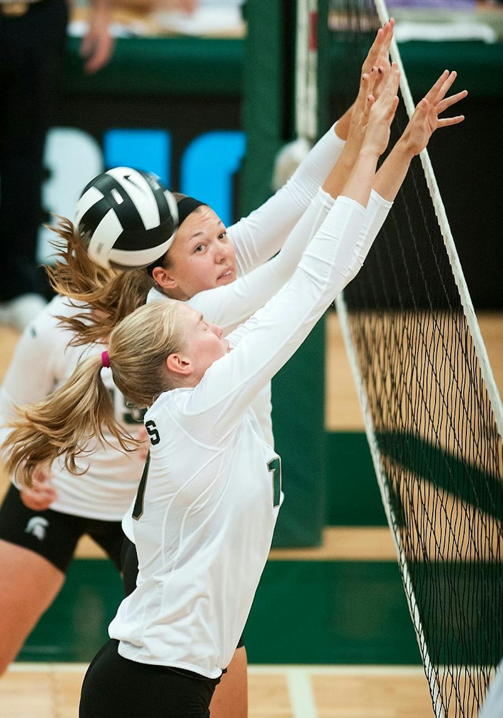 	<p>Senior middle blocker Kelsey Kuipers, left, and freshman middle blocker Megan Tompkins, right, miss a block during the Green and White game, Aug. 24, 2013, at Jenison Field House. The White team won 2-1. Danyelle Morrow/The State News</p>