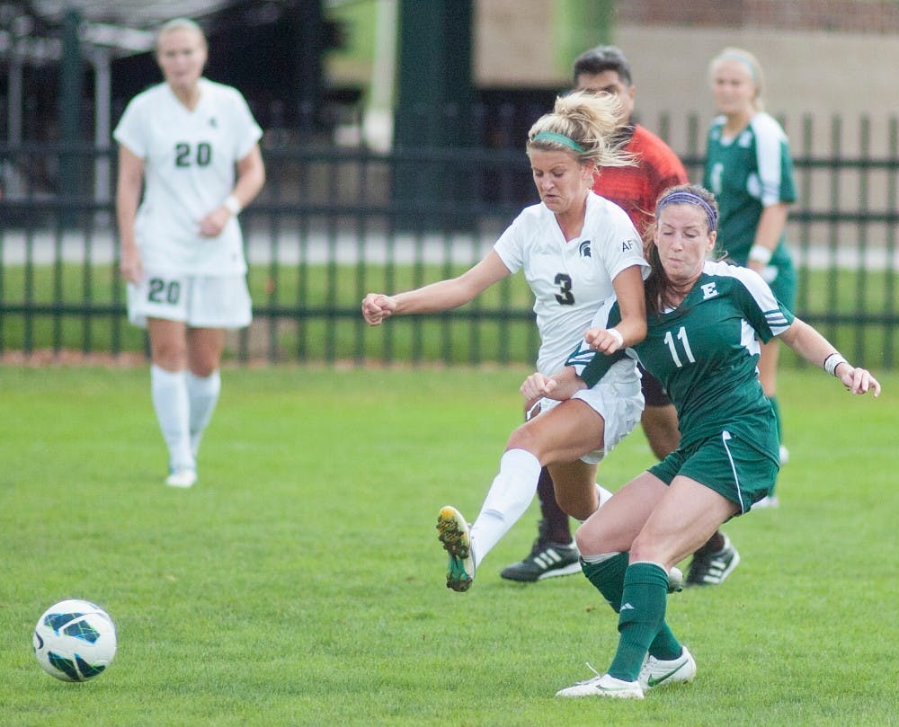 Sophomore midfielder Megan Marsack collides with Eastern Michigan's Cara Cutaia on Sunday, Sept. 9, 2012 at DeMartin Stadium. James Ristau/The State News