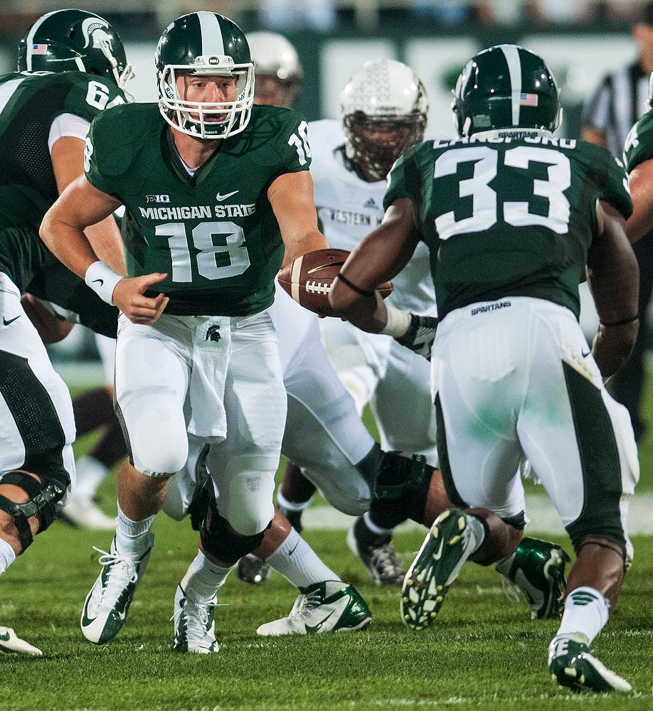 	<p>Sophomore quarterback Connor Cook hands off the ball to junior running back Jeremy Langford during their game against Western Michigan on Aug. 30, 2013, at Spartan Stadium. The Spartans defeated the Broncos, 26-13. Danyelle Morrow/The State News</p>