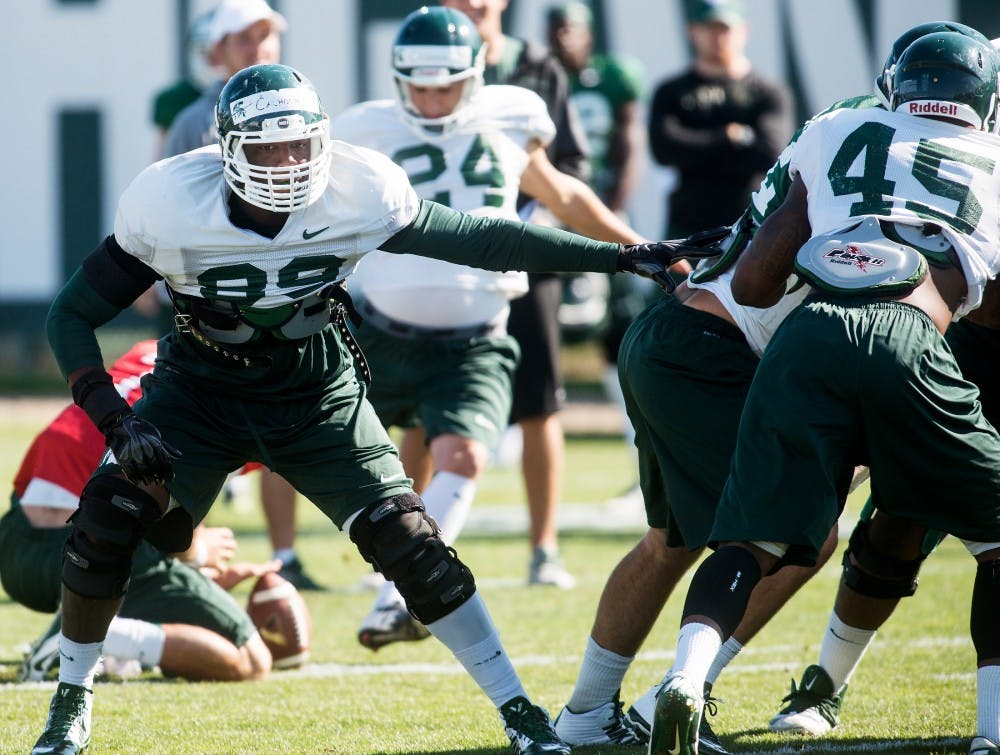 <p>Junior defensive end Shilique Calhoun participates in practice drills on Aug. 14, 2014, at the practice field outside of Duffy Daugherty Football Building. The season kicks off Aug. 29, with a game against Jacksonville State. Danyelle Morrow/The State News</p>