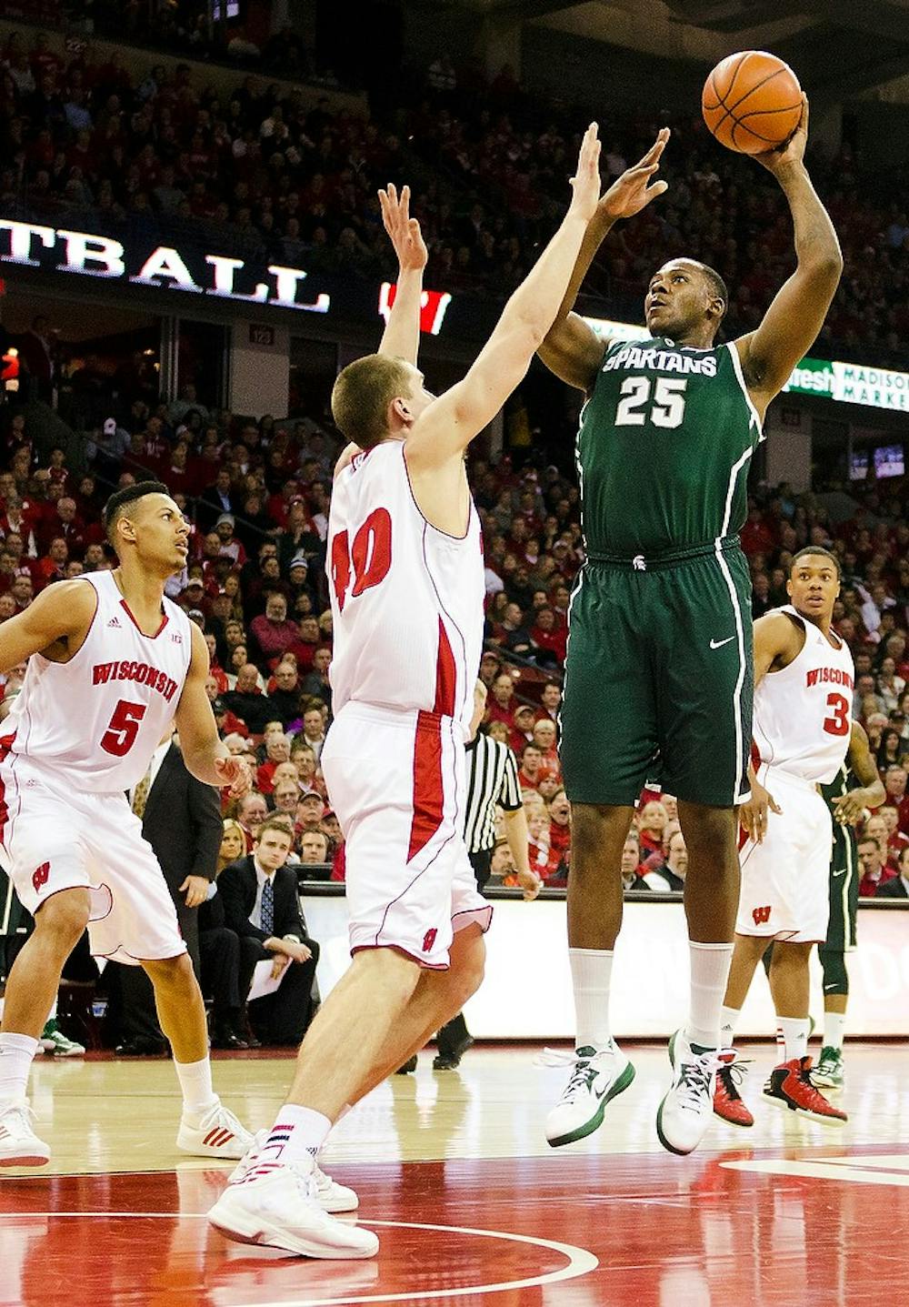 	<p>Senior center Derrick Nix takes a jump shot over Wisconsin defenders Tuesday, Jan. 22, 2013, at Kohl Center in Madison, Wisc. The Spartans defeated the Badgers 49-47 on the road. Grey Satterfield/The Daily Cardinal </p>
