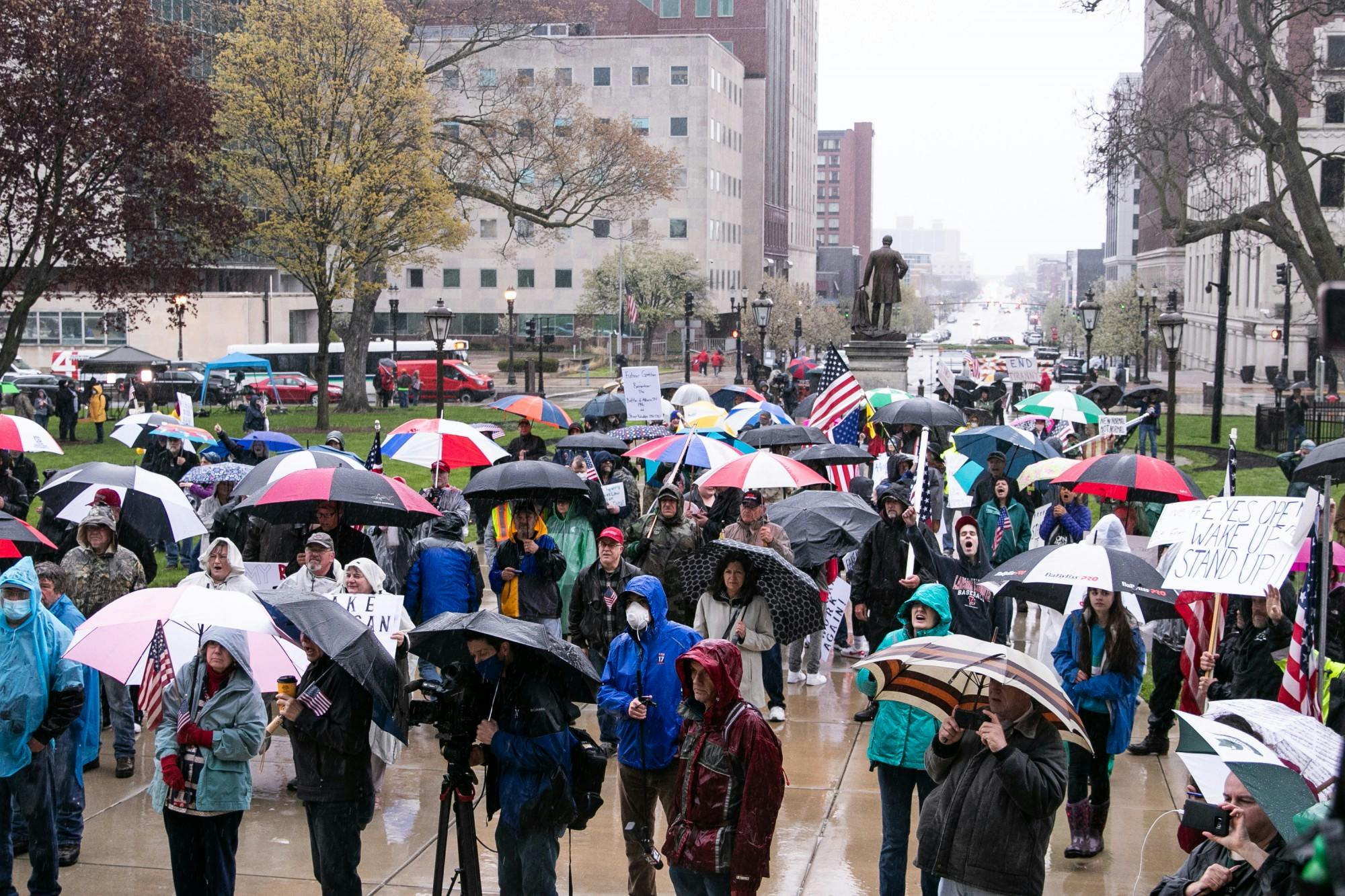 <p>A crowd listens to a speaker at the protest at the Capitol on May 14, 2020 in Lansing.</p>