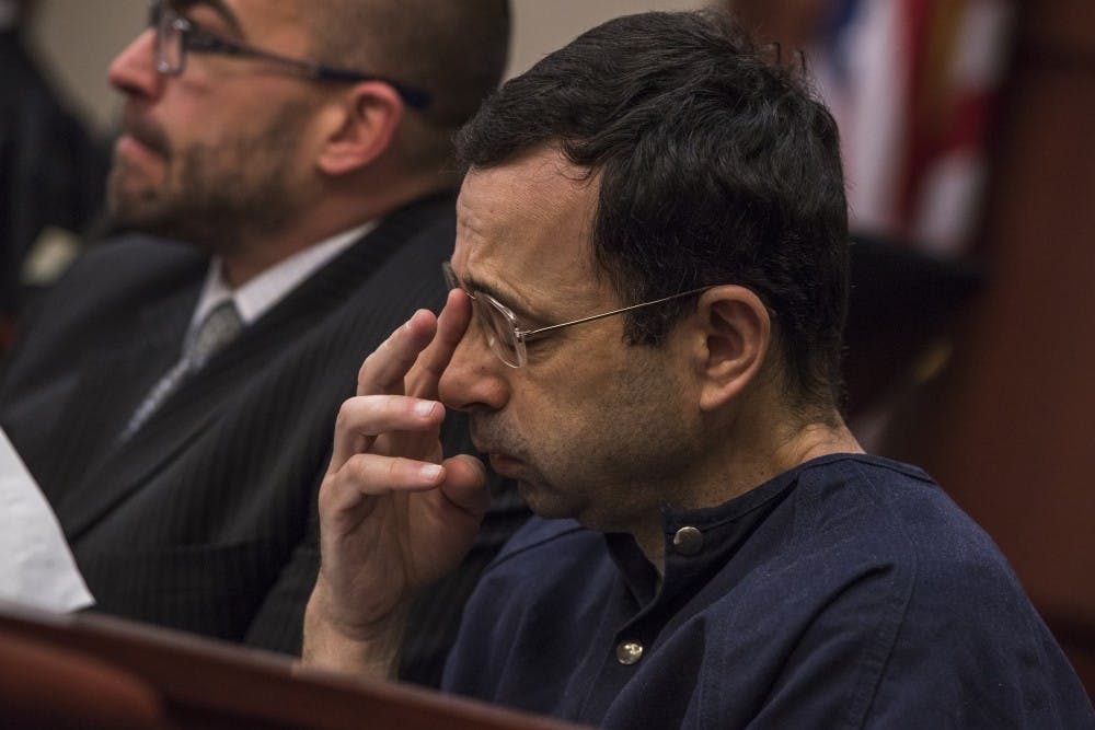 Ex-MSU and USA Gymnastics Dr. Larry Nassar rubs his face and lets out a deep breath on the sixth day of his sentencing on Jan. 23, 2018 at the Ingham County Circuit Court in Lansing. (Nic Antaya | The State News)