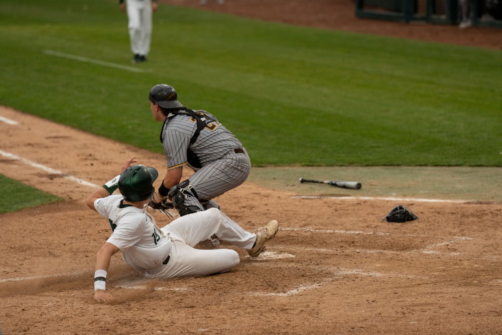 <p>Redshirt freshman catcher Bryan Broeker sides into home plate scoring MSU another run during the fourth inning on April 13, 2022. MSU would eventually lose 18-7 against Western Michigan.  </p>