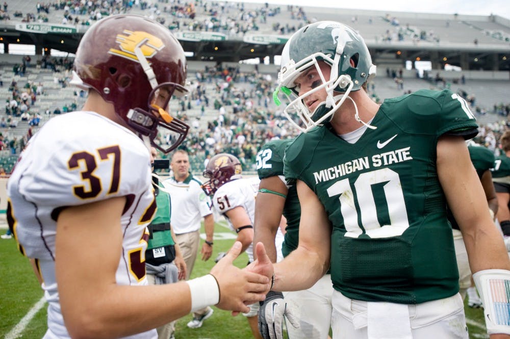 Sophomore quarterback Andrew Maxwell shakes hands with Central Michigan kicker Connor Gagnon after Saturday's game at Spartan Stadium. Maxwell and Gagnon both played for the Midland High School football team. Lauren Wood/The State News