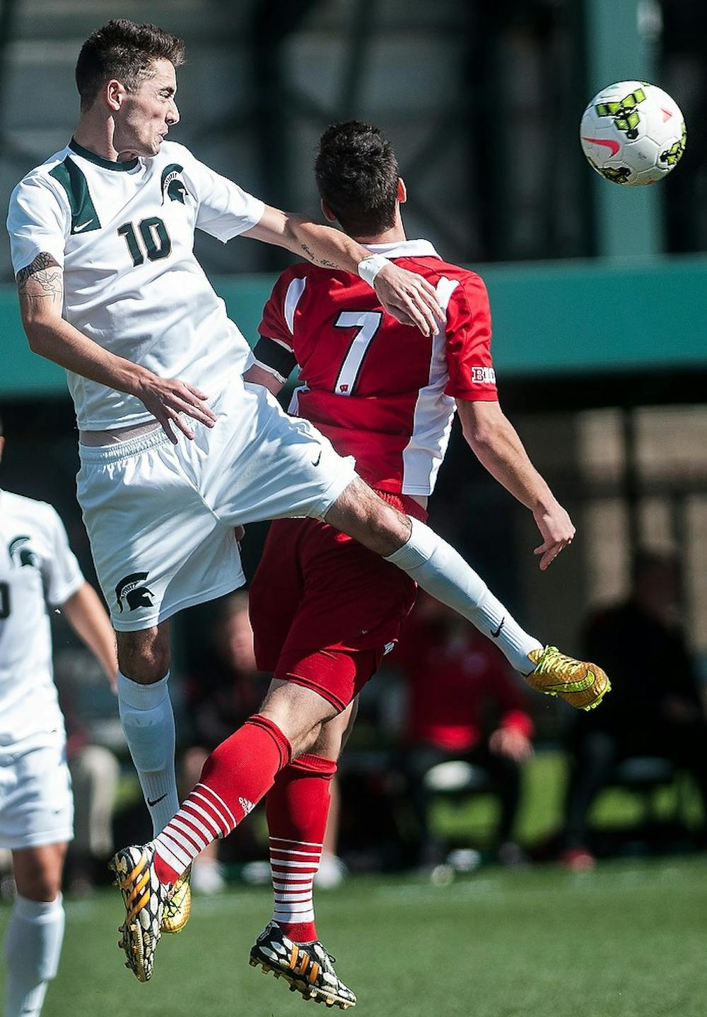 <p>Junior midfielder Jay Chapman heads the ball away from Wisconsin midfielder Drew Conner Oct. 11, 2014, during a game against Wisconsin at DeMartin Soccer Stadium at Old College Field. The Spartans defeated the Badgers, 2-1. Erin Hampton/The State News</p>