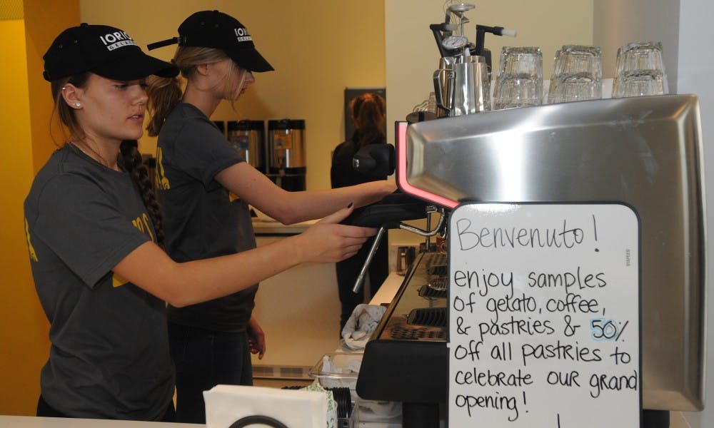<p>Criminal justice and psychology freshman Ashley Anderson, front, and advertising senior Taylor Orebaugh clean the coffee machines on Nov. 10, 2015 at Iorio's Gelato and Caffe, 1034 Trowbridge Road, in East Lansing during their grand opening.</p>