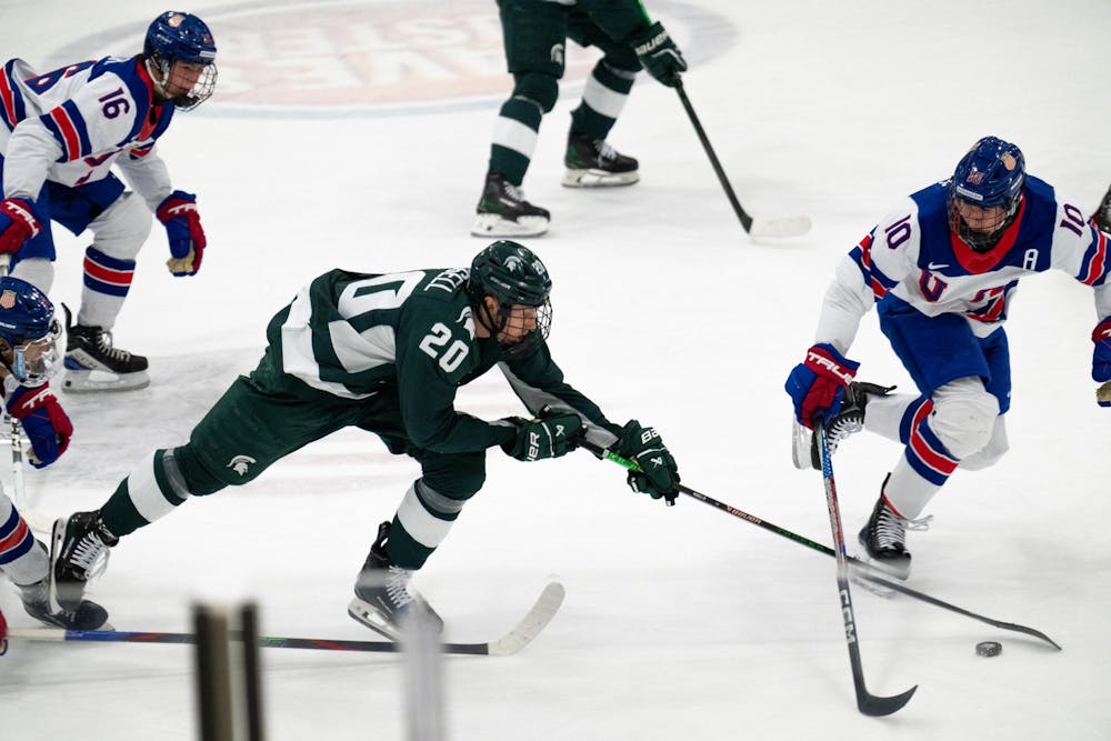 <p>Michigan State junior forward Daniel Russell (20) reaches for the puck against the under-18 U.S. Men's National Team Development Program at USA Hockey Arena in Plymouth, Michigan on Nov. 21, 2024. In front of a sold out crowd, the Spartans captured a convincing 6-2 victory, showcasing why they deserve their ranking of number two in the nation.</p>