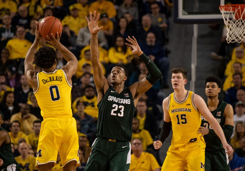 Junior forward Xavier Tillman (23) contests a shot during the game against Michigan Feb. 8, 2020 at Crisler Center. The Spartans fell to the Wolverines, 77-68.