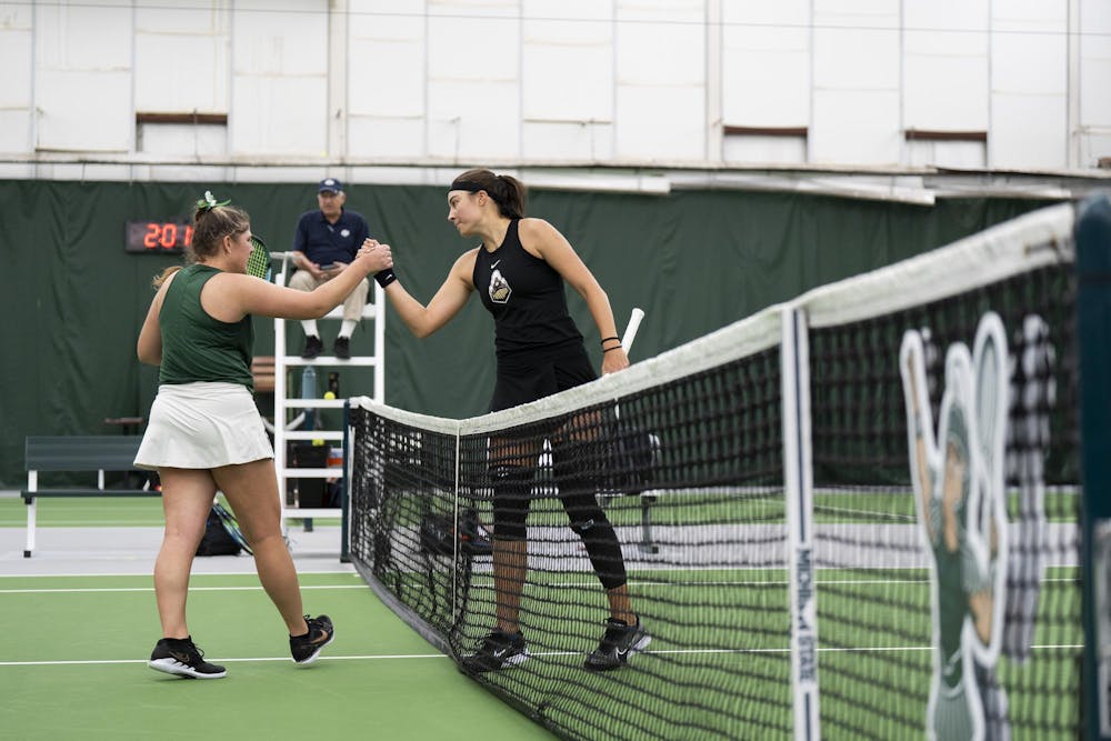 MSU grad student Nicole Conard shakes Purdue Junior Tara Katarina Milic's hand at the end of the match at the MSU Tennis Facility on Mar. 30, 24.