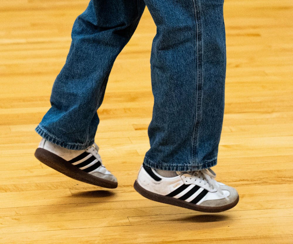 a dance jumps in between moves at IM Circle, in East Lansing, on Dec. 2nd, 2025.