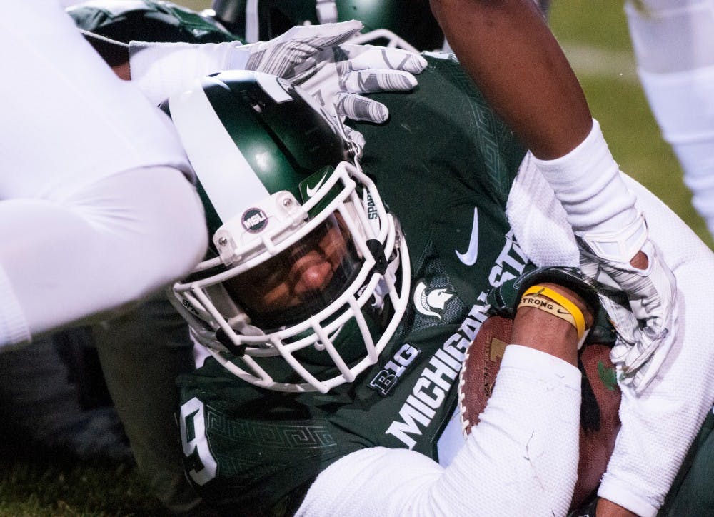 Junior cornerback Jermaine Edmondson recovers a fumbled ball during the fourth quarter of the game against Penn State on Nov. 28, 2015 at Spartan Stadium. The Spartans defeated the Nittany Lions, 55-16.