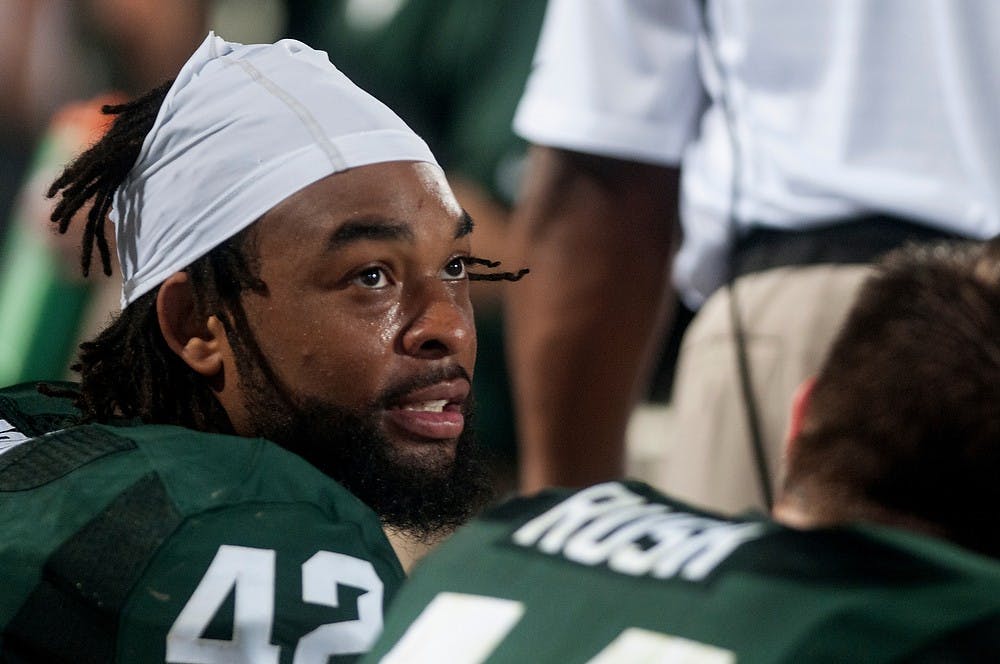 	<p>Senior defensive end Denzel Drone looks up at the scoreboard on Aug. 30, 2013, at Spartan Stadium. The Spartans defeated the Broncos, 26-13. Katie Stiefel/The State News</p>