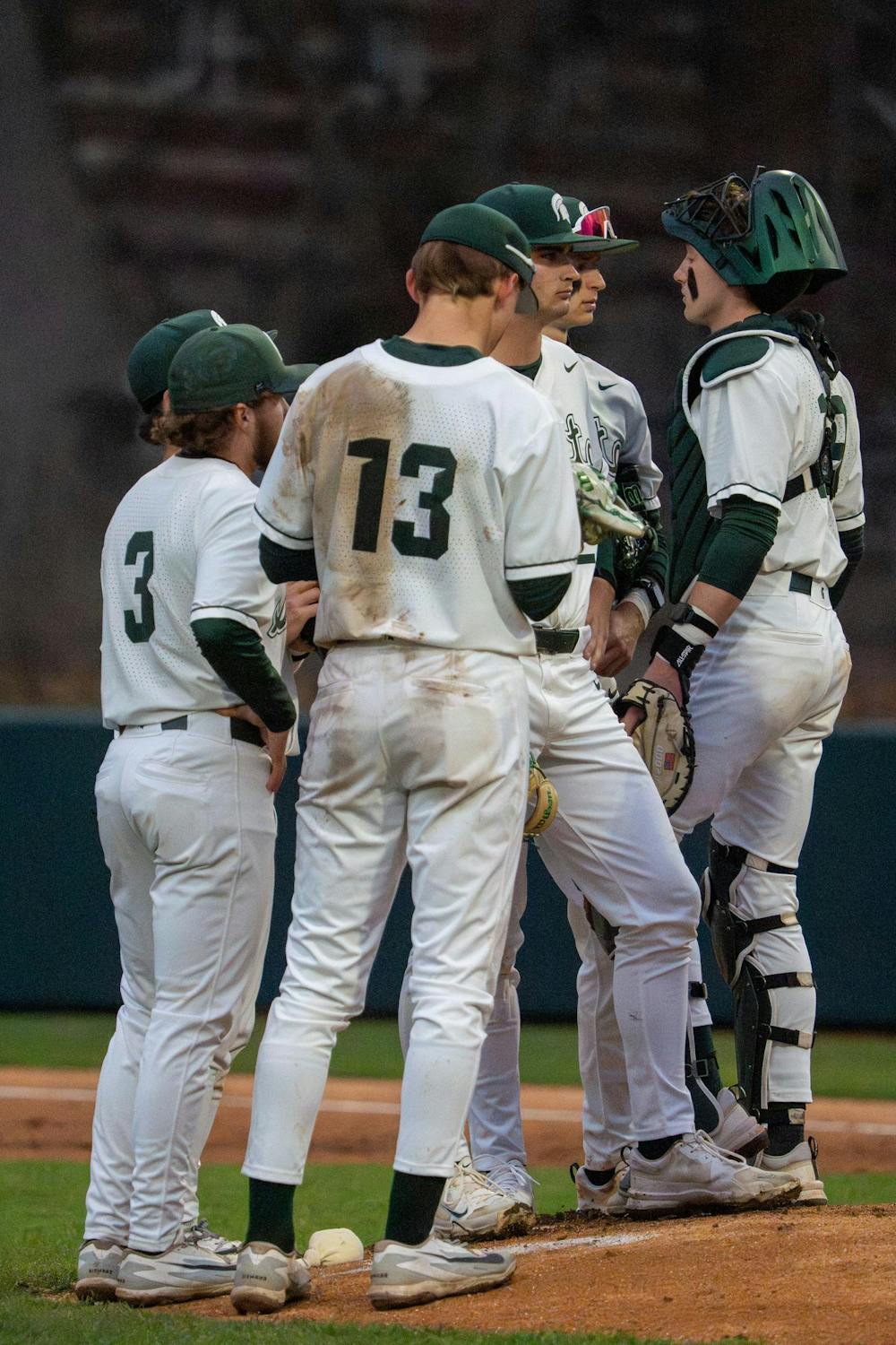 Michigan State players talk on the field between plays during Michigan State’s game against Michigan at Jeff Ishbia Field at McLane Stadium in East Lansing, Mich., on Friday, April 10, 2026.