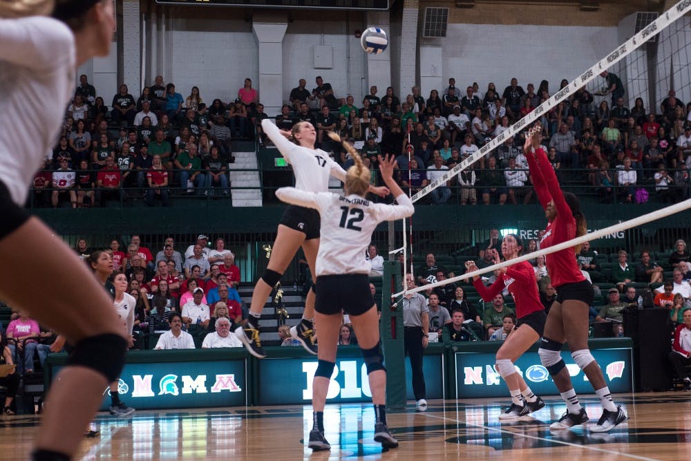 Senior setter Rachel Minarick (12) sets the ball for junior middle blocker Alyssa Graveling (17) during the game against Nebraska on Sept. 24, 2016 at Jenison Field House. The Spartans were defeated by the Corn Huskers 3-2.