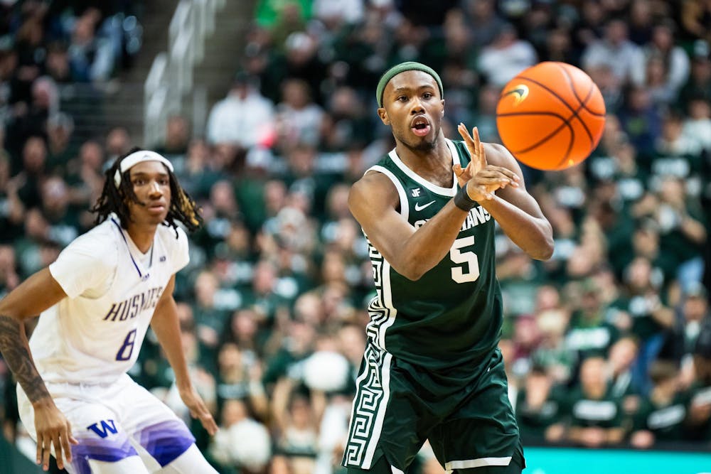 Michigan State junior guard Tre Holloman (5) passes the ball during a game against the University of Washington at the Breslin Center in East Lansing, Michigan on January 9, 2025. Michigan State won 88-54.