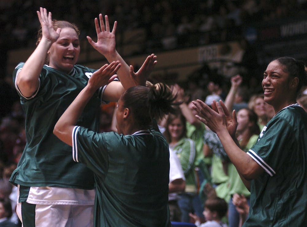 From left, sophomore center Katrina Grantham, freshman forward Melanie Small and sophomore forward Myisha Bannister celebrate as the Spartans took the lead over Vanderbilt Sunday night at Municipal Auditorium in Kansas City, Mo. The team overcame a seven point first half deficit to win 76-46.Tyler Sipe/The State News