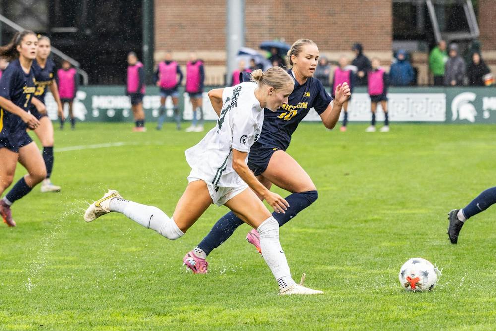 <p>MSU junior defender Faith George (14) fights off Michigan senior defender Campbell Jewell (10) early in the first half of the rivalry game in East Lansing, Mich., on Sept. 20, 2026.</p>