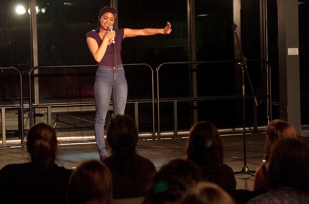 <p>Comedian Tanisha Long performs stand-up April 5, 2014, at the International Center. Long is a cast member in MTV's show "Girl Code" and joked about her relationship issues throughout her set. Emily Jenks/The State News</p>