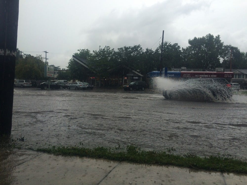 <p>East Grand River Avenue by Milford Street under heavy flooding conditions on Monday.</p>