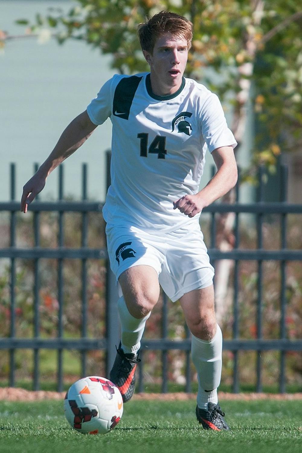 	<p>Freshman midfielder Dewey Lewis runs the ball during the game on Oct. 13, 2013, at DeMartin Stadium at Old College Field. The Spartans tied the Buckeyes, 1-1. Georgina De Moya/The State News</p>