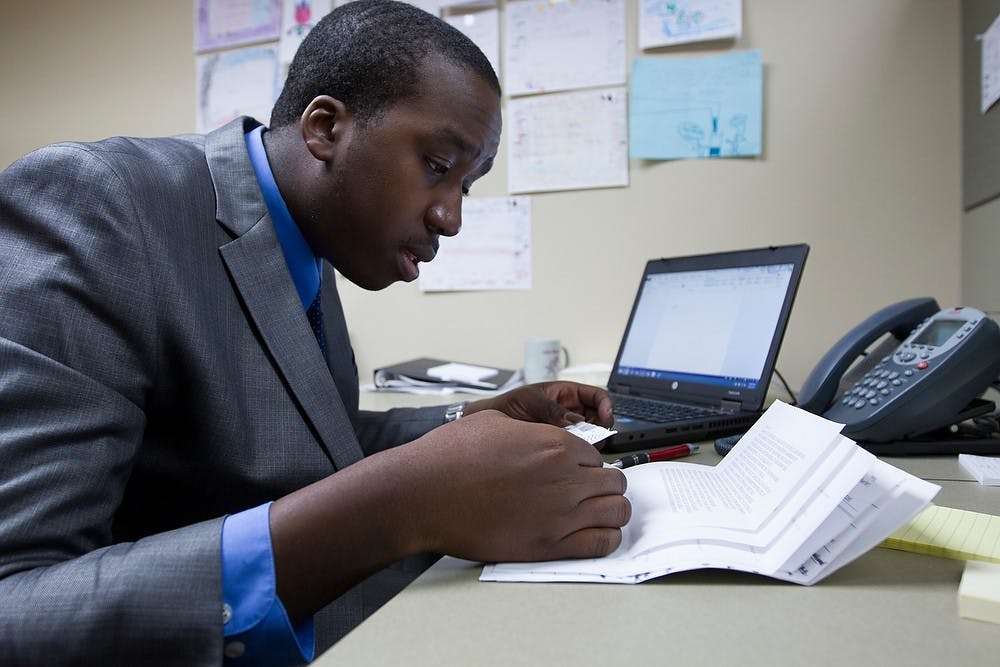 <p>James Madison freshman Ron Owens III reads constituent mail March 24, 2015, in the office of State Rep. Adam Zemke, D-Ann Arbor, at 124 N. Capitol Ave. in Lansing. Interns like Owen often read and respond to constituent mail and help with research on legislation. Simon Schuster/The State News</p>