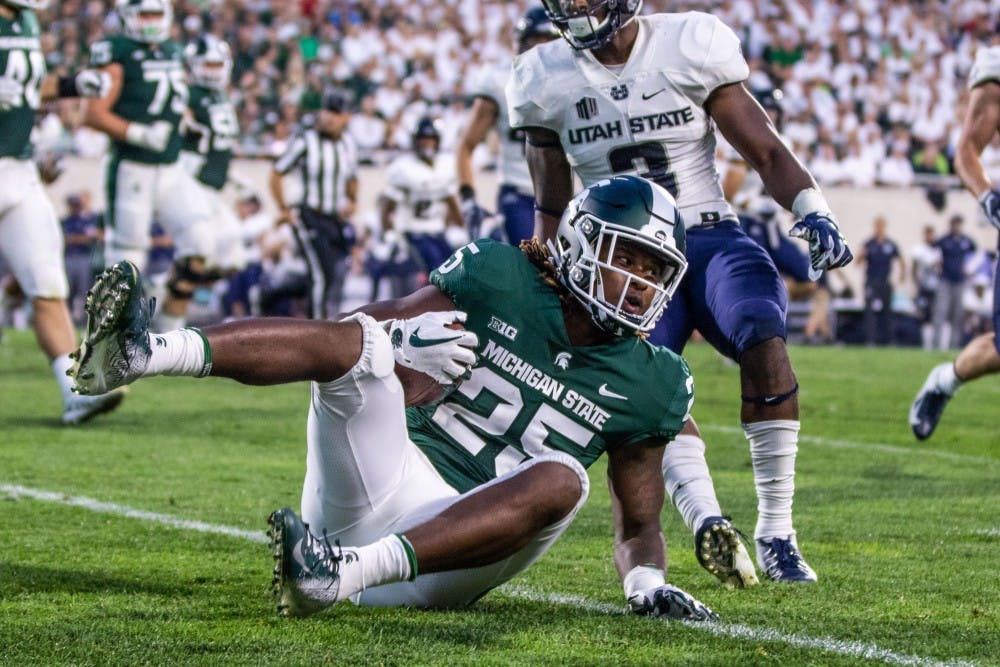 Junior wide receiver Darrell Stewart (25) hits the ground after being tackled during the game against Utah State on Aug. 31 at Spartan Stadium. The Spartans led the Aggies, 20-14 at the half.