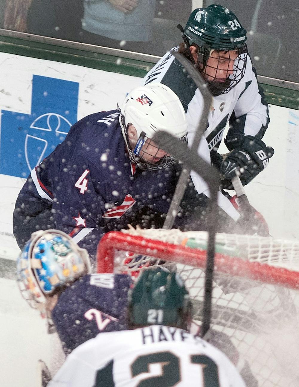 	<p>Redshirt freshman forward Justin Hoomaian battles for the puck with U.S. National Team Development Program defenseman Will Butcher on Tuesday, Jan. 22, 2013, at Munn Ice Arena. <span class="caps">MSU</span> lost the exhibition game 3-0. Danyelle Morrow/The State News</p>