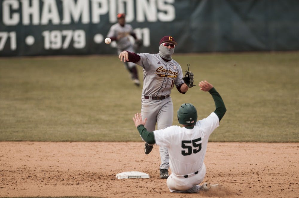 <p>Senior first baseman Zack McGuire (55) slides into second base as Central Michigan second baseman Jason Sullivan (10) throws over him during the game against Central Michigan on March 21, 2018 at McLane Baseball Stadium. The Spartans fell to the Chippewas, 3-1. (C.J. Weiss | The State News)</p>