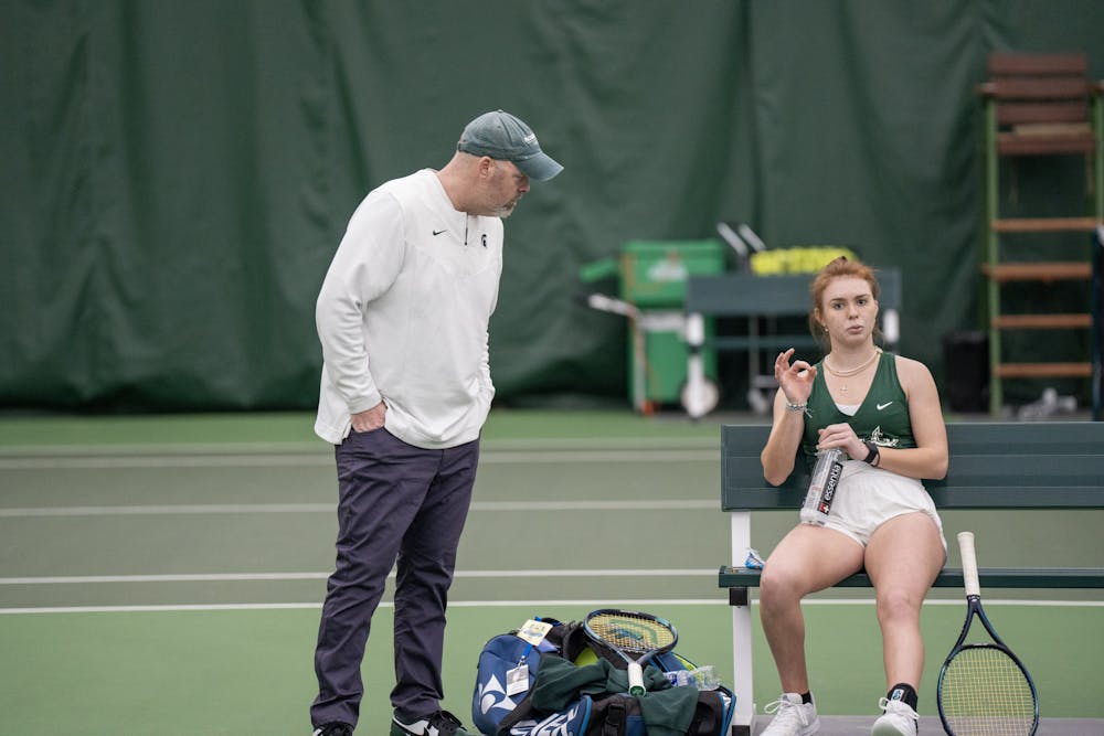 <p>Freshman Juliette Nask speaks to Assistant Head Coach Tyler Faulkner during her singles match against Illinois State on Feb. 26, 2023.</p>