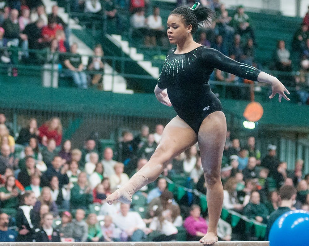 	<p>Sophomore Alina Cartwright poses on the balance beam during the meet against Ohio State Saturday at Jenison Field House. Cartwright finished fourth place with a score of 9.8. Danyelle Morrow/The State News</p>