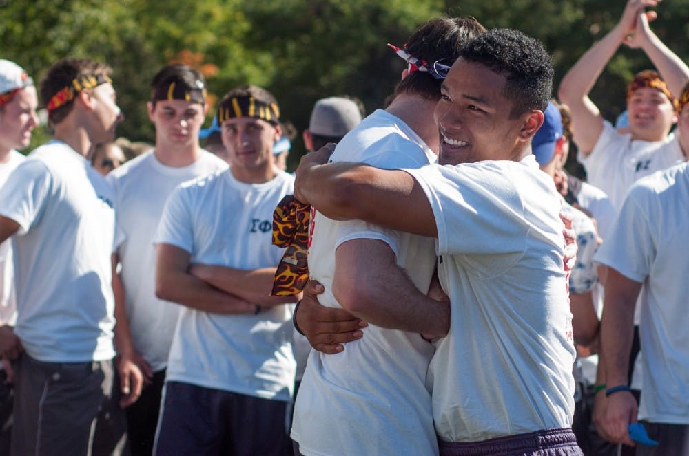 <p>Advertising junior Robert Page, right, hugs chemical engineering junior William Millar during the annual Sigma Olympics, hosted by Sigma Kappa, on Sept. 27, 2015, at Patriarche Park in East Lansing.</p>