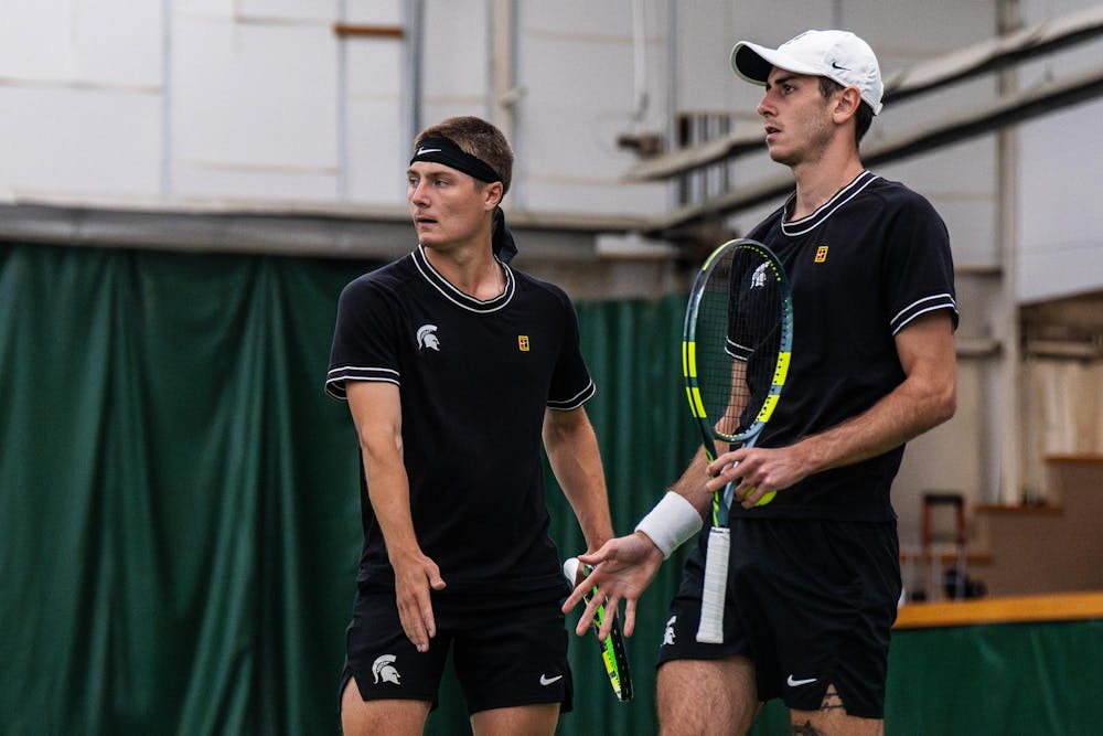 <p>Mitchell Sheldon, a Michigan State sophomore, and Aristotelis Thanos, a senior, high-five between points during a doubles match against Purdue at the MSU Tennis Center in Lansing, Mich., Sunday, April 19, 2026.</p>