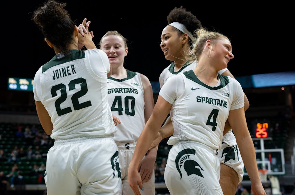 The Spartans celebrate after scoring. Michigan State defeated Detroit Mercy 91-41 in the Breslin Student Events Center on Dec. 18, 2022.