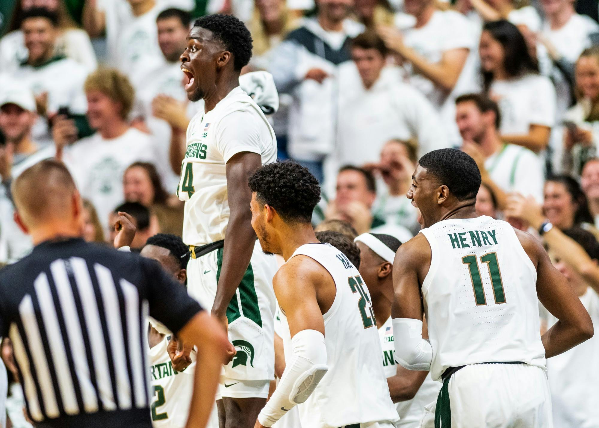 Sophomore forward Gabe Brown (left) leaps in excitement after freshman guard Steven Izzo scored his first point as a SpartanThe Spartans defeated the Britons, 85-50, at half at the Breslin Student Events Center on October 29, 2019. 