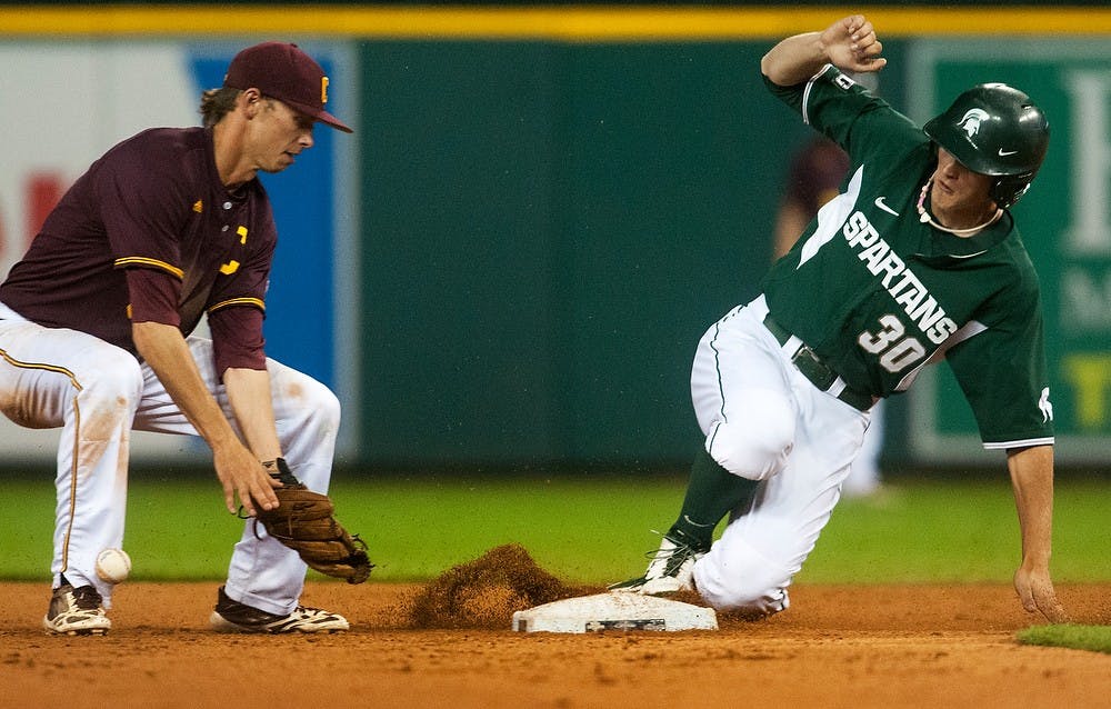 <p>Then-sophomore left fielder Cam Gibson slides into second as then Central Michigan infielder Alex Borglin misses a catch May 13, 2014, at Comerica Park in Detroit. The Chippewas defeated the Spartans, 7-4. Danyelle Morrow/The State News</p>