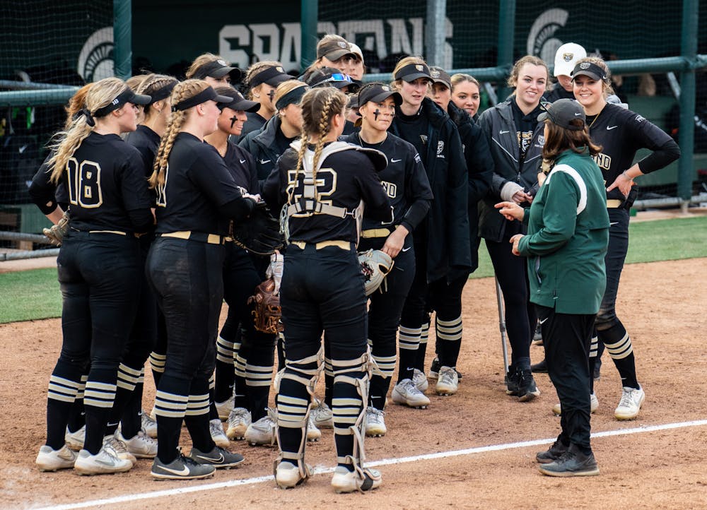 <p>Coach Jacquie Joseph talks to the Oakland team after their win. The Spartans fell to the Golden Grizzlies, 10-5, on April 5, 2022. </p>
