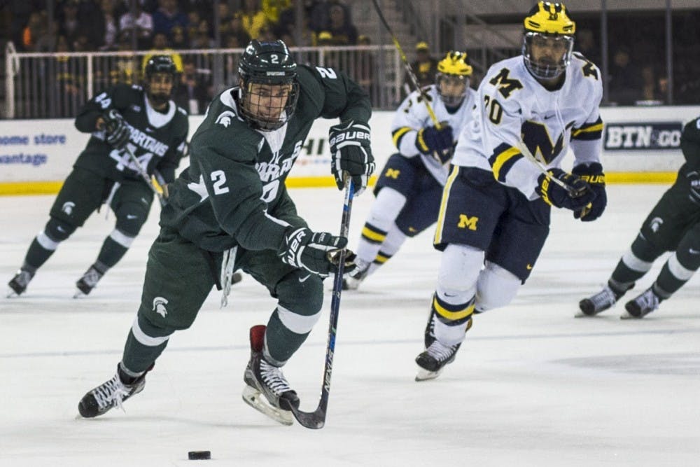 Sophomore defense Zach Osburn (2) takes the puck down the rink during the second period of the men’s hockey game against the University of Michigan on Feb. 11, 2017 at Yost Ice Arena in Ann Arbor. The Spartans defeated the Wolverines, 4-1.