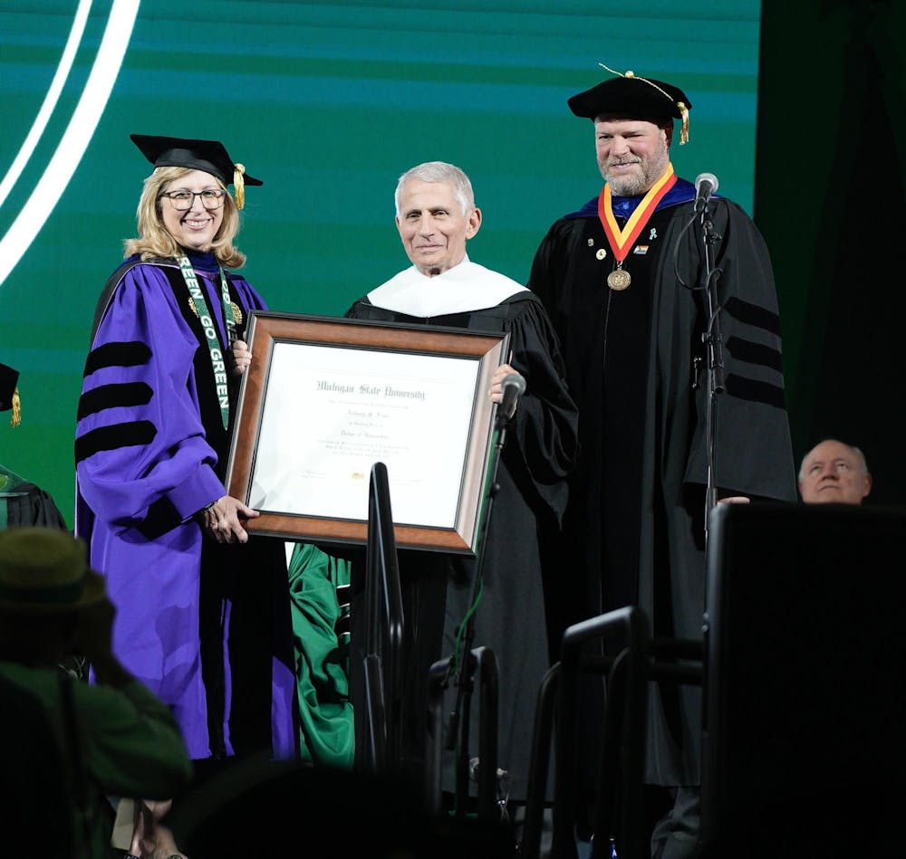 Dr. Anthony Fauci is presented with an honorary doctoral degree at the 2023 commencement ceremony.