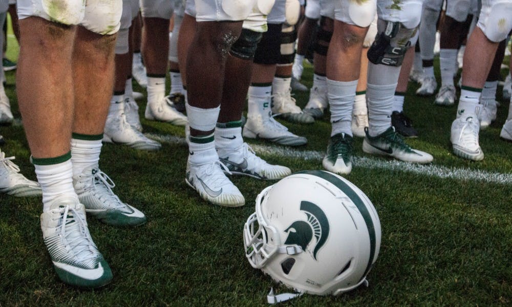 <p>An MSU football helmet pictured on the field following the game against Western Michigan University on Sep. 9, 2017 at Spartan Stadium. The Spartans defeated the Broncos 28-14.</p>
