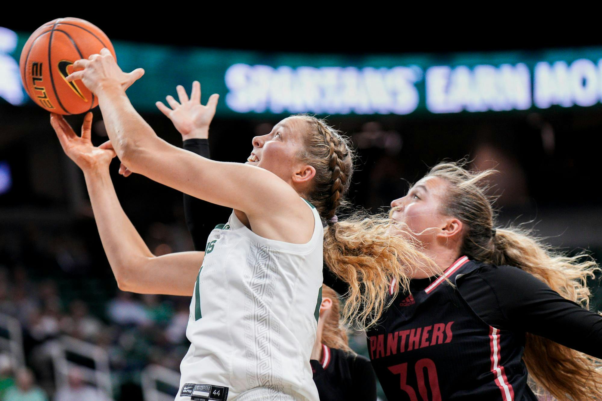 <p>Freshman center Mary Meng (21) reaches for the rebound during the season-opening exhibition game against Davenport University at the Breslin Center on Nov. 2, 2023.</p>