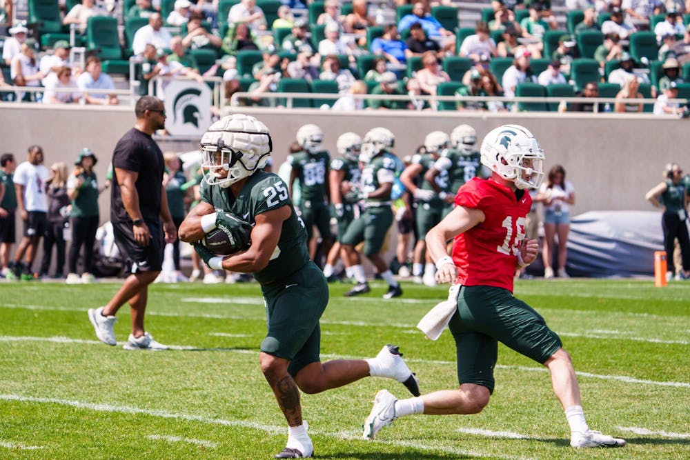 <p>Redshirt junior running back Joseph Martinez (25) runs the ball during a scrimmage at the MSU football open spring practice on April 15, 2023.</p>