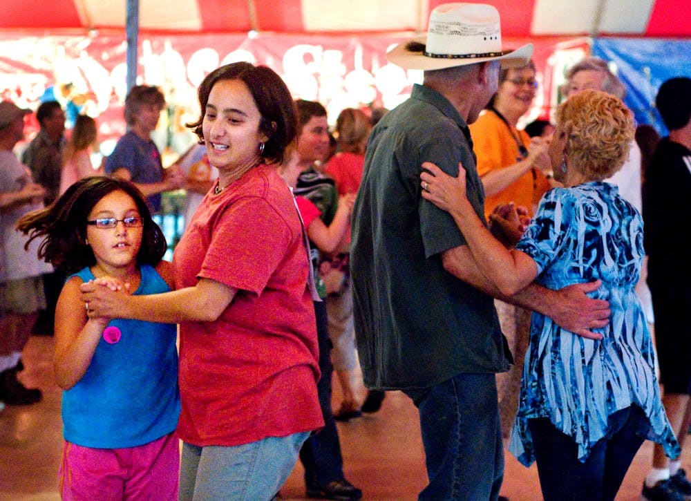 	<p>From left, Lansing residents Katarina, 9, and Tamiko Rothhorn dance with Mason residents Tom and Marla Warren Saturday afternoon at the Great Lakes Folk Festival. Festival attendees could participate in a variety of dances throughout the day at the Dance Stage. </p>