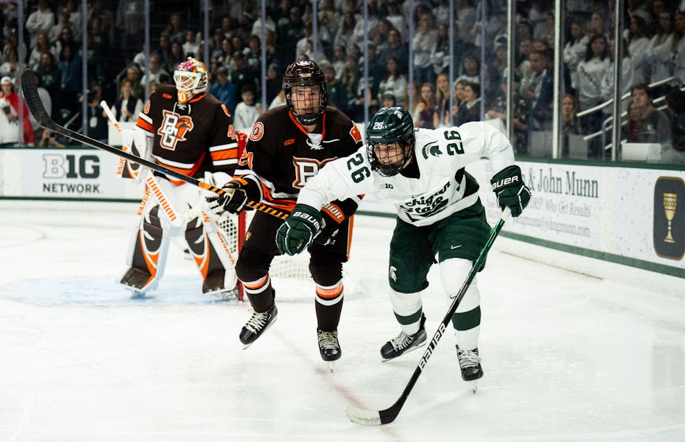 <p>Sophomore forward Tanner Kelly (26) sprints for the puck during a game against Bowling Green State University at Munn Ice Arena on Oct. 7, 2022. The Spartans lost against the Falcons with a score of 3-1. </p>