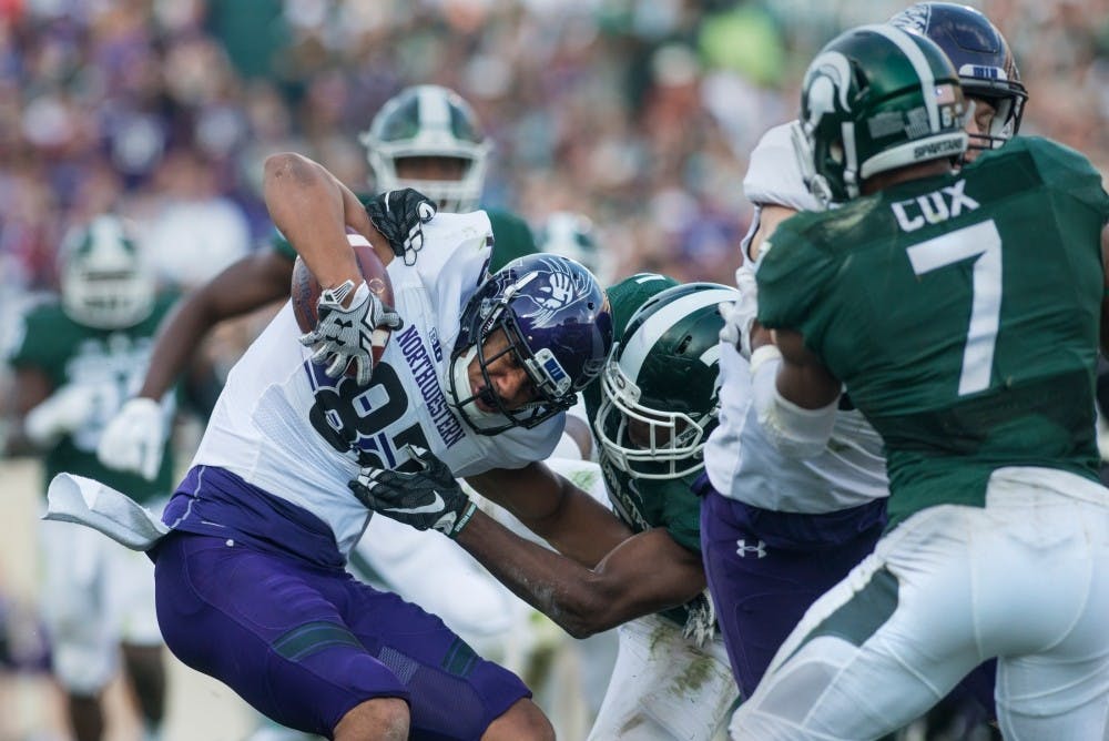 <p>Senior wide receiver R.J Shelton (12) catches the ball and is then tackled by Northwestern quarterback Clayton Thorson (18) during the game against Northwestern on Oct. 15, 2016 at Spartan Stadium. The Spartans were defeated by the Wildcats, 54-40.</p>
