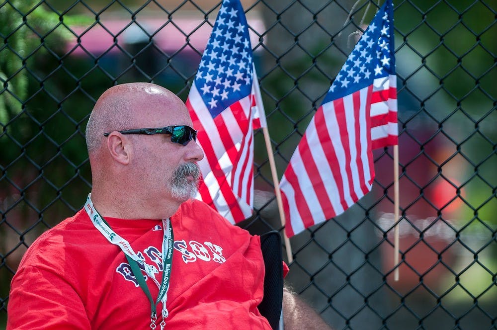 	<p>Rochester, Mass., resident Jim Winsper watches the shot put competition on August 3, 2013 at Ralph Young Field during the World Dwarf Games. Winsper was watching his son compete in the world games. Weston Brooks/The State News</p>